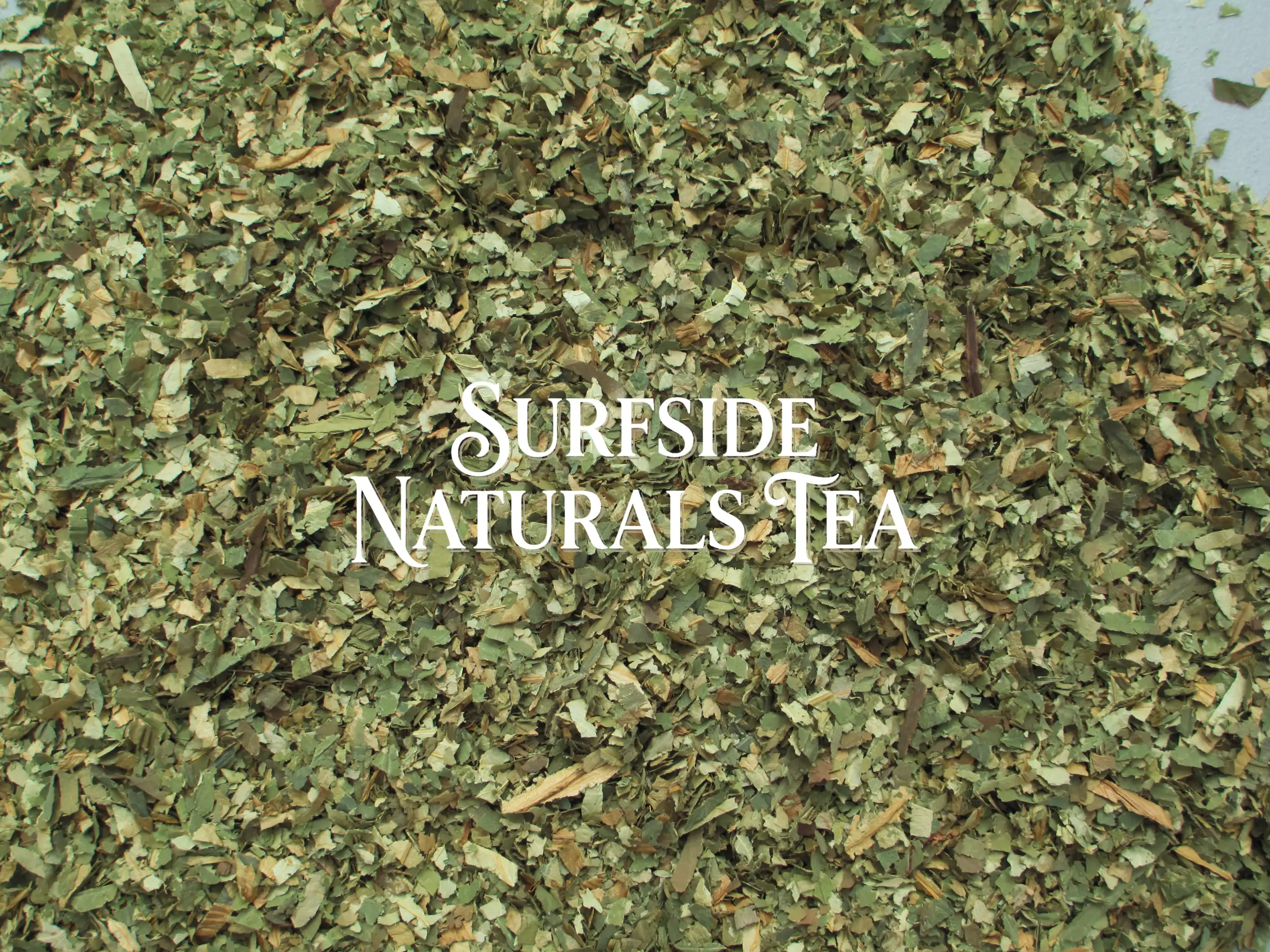 Sacred lotus leaf herbal tea made from clean dried leaves cut into pieces about ¼ to ½ inch wide and 1–2 inches long, ranging from light to dark green with some tan pieces, with a "Surfside Naturals Tea" watermark in the center.